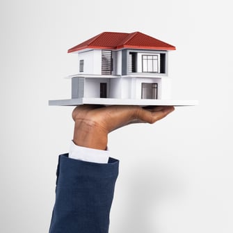 hand-holding-house-real-estate-property-model