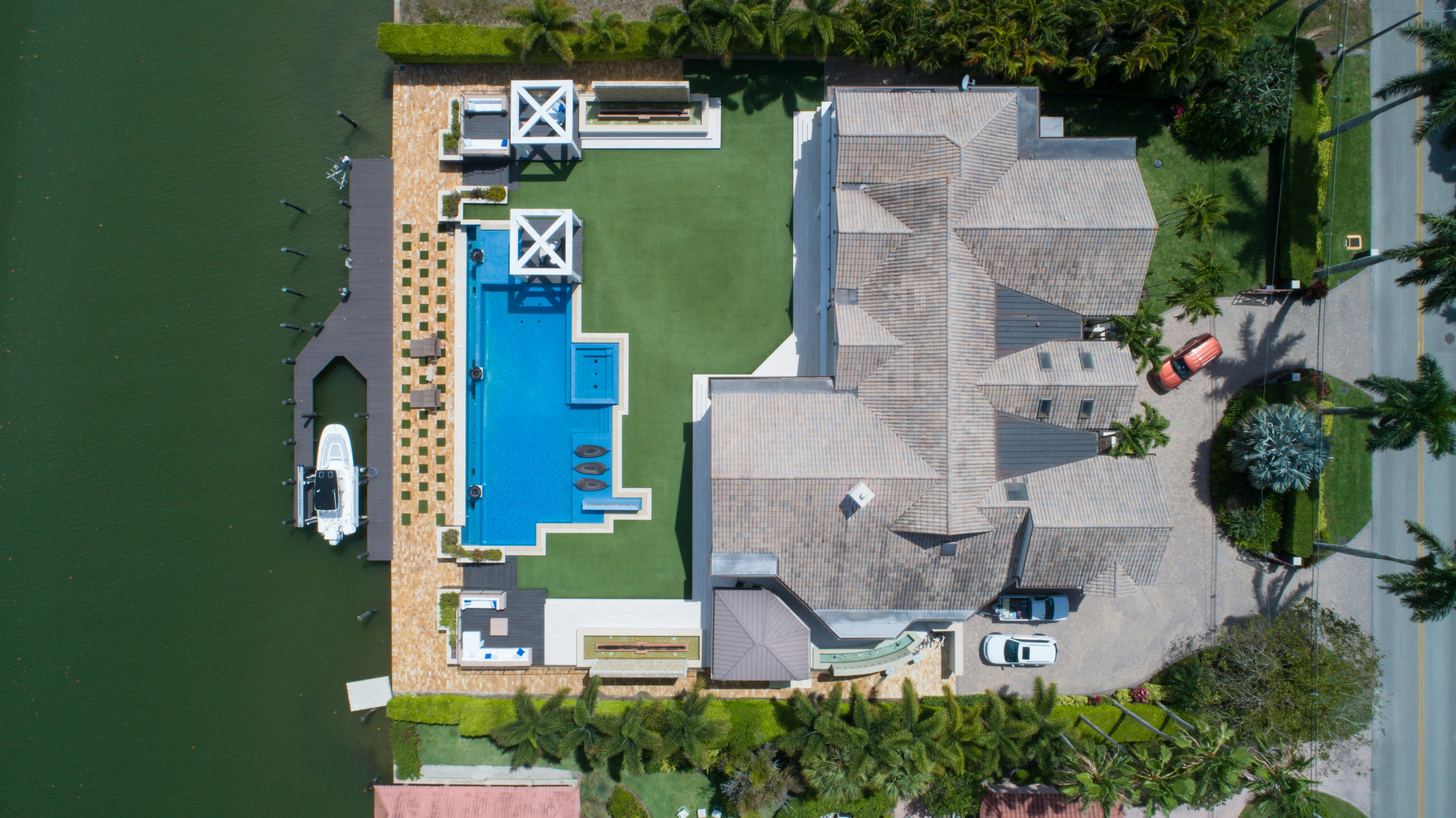 huge mansion house shot from above with the pool and backyard