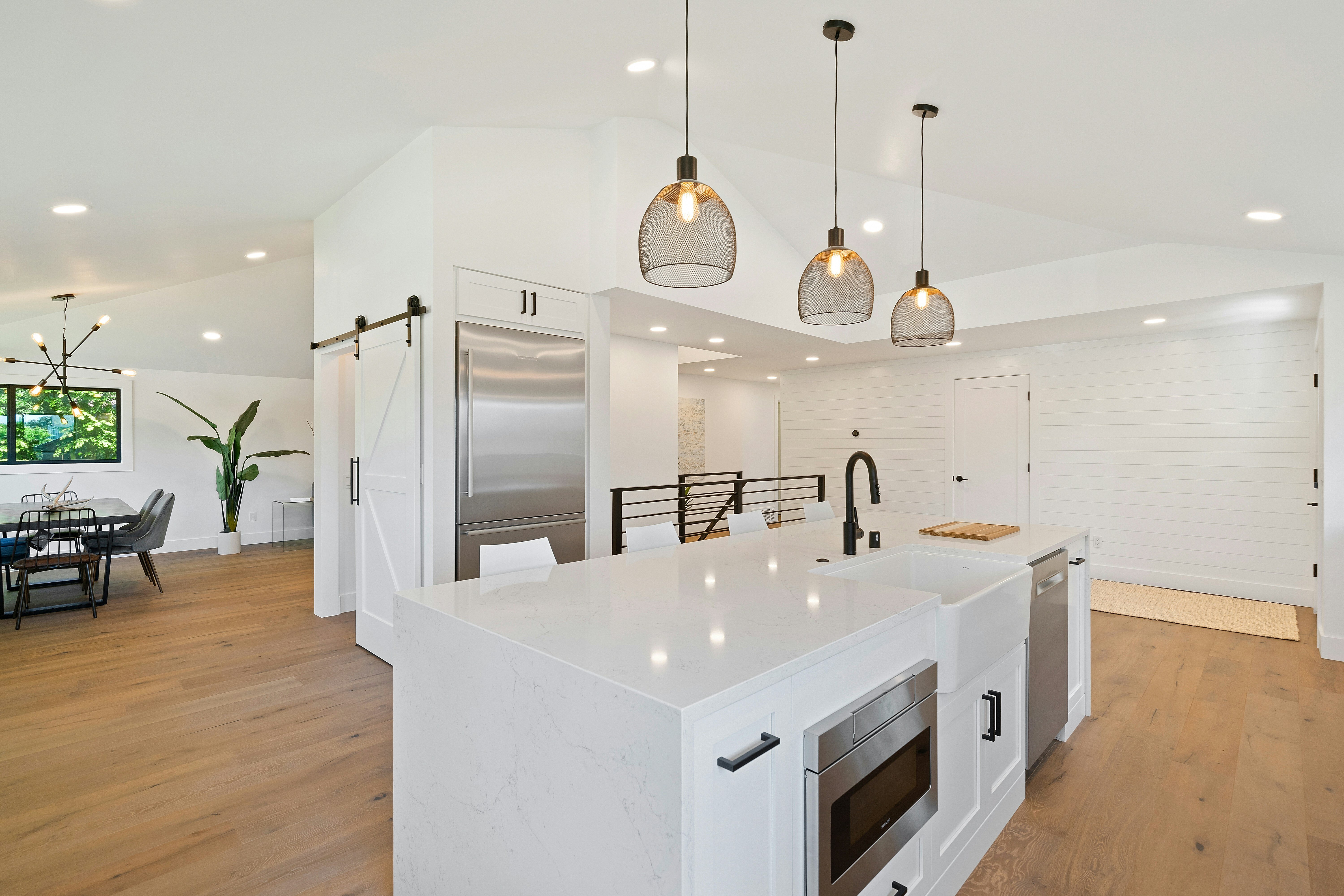 nice white colored kitchen with marble island
